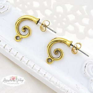 May include: Two gold-tone earring findings with a spiral design. The findings have a post and butterfly backing.