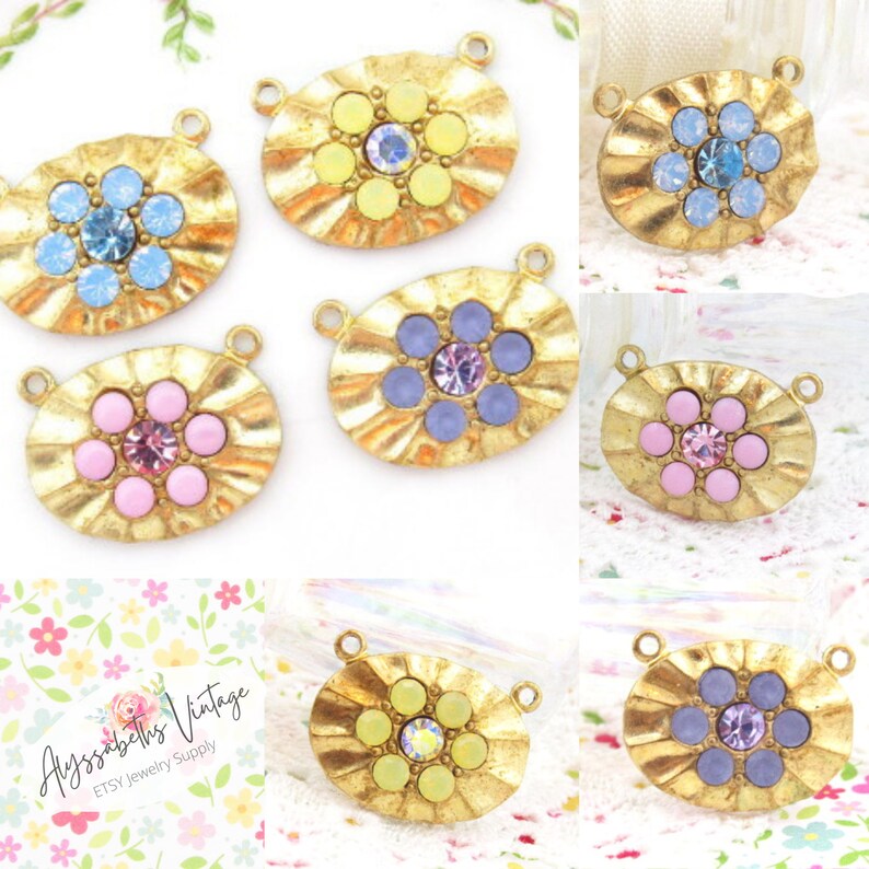 May include: Six gold-tone oval-shaped metal charms with a flower design. Each charm has a different colored center with rhinestones. The colors are light blue, yellow, pink, purple, and two shades of purple.
