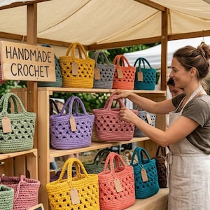 May include: A wooden display stand holds multiple handmade crochet bags in various colors including pink, yellow, green, purple, and teal. Each bag features a triangular open-weave pattern, two handles, and a blank brown paper tag.