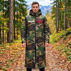 May include: A long, hooded camouflage coat featuring a green, brown, and black pattern. The chest area displays the text "YOUR NAME" in white and a red "RF" logo. The coat has a full-length front zipper, long sleeves, and a thick, insulated design.