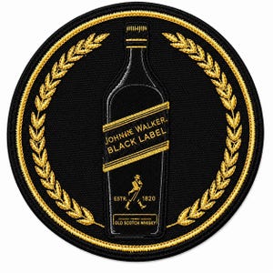 May include: A circular black embroidered patch featuring a gold-stitched whiskey bottle in the center. The bottle label reads Johnnie Walker Black Label with the text ESTR. 1820 and Old Scotch Whisky. A gold laurel wreath encircles the bottle.