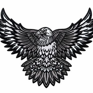 May include: An embroidered patch featuring a bald eagle in flight with wings fully spread. The design uses a monochromatic color palette of black, white, and shades of gray, with detailed stitching outlining the feathers and the eagle's head.