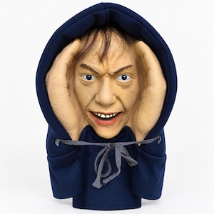 May include: A sculpted bust of a human face with a wide-eyed, open-mouthed expression, framed by two large hands pressed against the sides of the head. The figure wears a dark navy blue hooded sweatshirt with a grey drawstring tied at the neck.