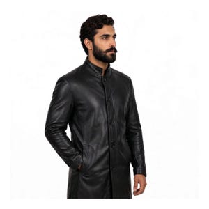 May include: A black leather coat featuring a stand-up collar, a front button closure with five visible buttons, long sleeves, and side pockets. The coat has a smooth finish and a structured fit, extending past the waistline in a classic design.