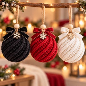 May include: Three spherical Christmas ornaments featuring a textured, ribbed knit pattern in black, red, and white. Each ornament is topped with a wooden bead, a velvet ribbon bow, and a small wooden snowflake charm, suspended by a jute twine loop.