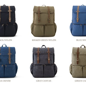 May include: Six different backpacks in various colors and materials. The backpacks are all the same style, with two large pockets on the front and a flap with two buckles. The colors are black nylon, khaki green nylon, blue nylon, blue denim, gray canvas, and green canvas.