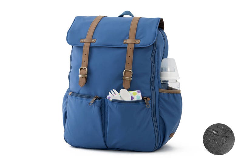 May include: A blue diaper bag backpack with brown straps and multiple pockets. The bag has a bottle holder on the side and a zippered pocket on the front.