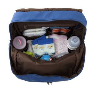 May include: A blue diaper bag with a brown interior. The bag is open and filled with baby items, including diapers, socks, a bottle, and a toy.