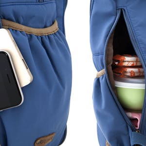 May include: A blue backpack with two zippered pockets. The left pocket has a phone and a white charger inside. The right pocket has a container of food inside.
