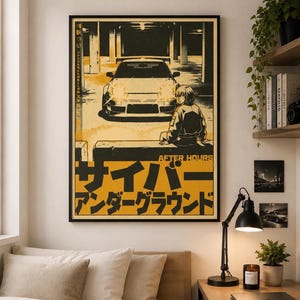 May include: A framed wall poster featuring a yellow and black graphic illustration of a sports car in a parking garage with a person sitting in front of it. The text reads "AFTER HOURS" and includes Japanese characters in a bold, stylized font.