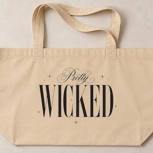 May include: A beige canvas tote bag with two top handles. The front features the text Pretty WICKED in a combination of elegant script and bold serif typography, accented by small four-pointed star symbols surrounding the lettering.