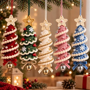 May include: Five hanging Christmas tree ornaments made of crocheted yarn in red, green, white, pink, and blue. Each tree features a cream-colored star topper, a spiral trim with beads or snowflakes, and a metallic jingle bell tied with a ribbon.
