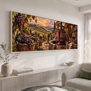 May include: A rectangular wall art print depicting a vineyard scene at sunset. The image features large clusters of purple grapes in woven baskets, two figures harvesting in the distance, and a wooden wine press overflowing with red grape juice.