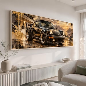 May include: A rectangular wall art print featuring a black sports car parked on a wet surface. The scene includes golden paint splatters, a modern building structure, and a sunset landscape with mountains and water in the background.