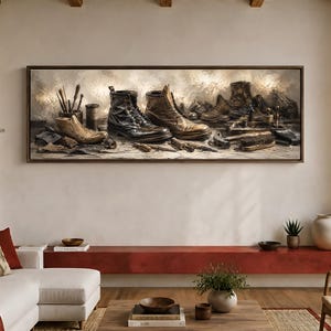 May include: A panoramic framed wall art piece depicting a cobbler's workbench with two leather boots, a wooden shoe last, various metal hand tools, brushes, and spools of thread arranged on a textured surface in a muted, earthy color palette.