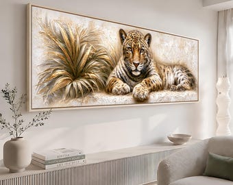 May include: A rectangular wall art piece featuring a realistic leopard resting beside a large, textured golden plant. The artwork is set against a cream-colored background with visible brushstroke textures, framed in a light-colored wooden border.