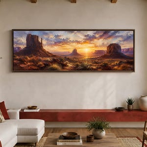 May include: A panoramic landscape painting in a dark brown frame depicting a desert scene with large rock formations under a vibrant sunset sky. The artwork features warm orange, yellow, and purple hues across the clouds and horizon line.