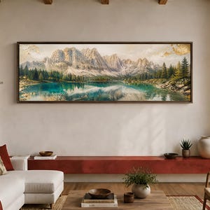 May include: A panoramic landscape painting in a dark brown frame depicting a jagged mountain range with snow-capped peaks, a dense forest of evergreen trees, and a calm turquoise lake reflecting the mountains, all rendered in textured oil paint.