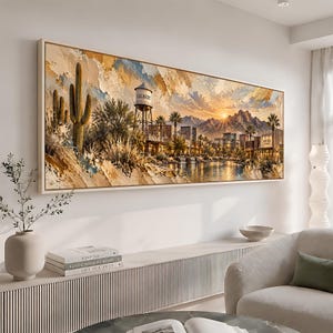 May include: A rectangular wall art print featuring a desert landscape at sunset. The scene includes a water tower labeled Gilbert, tall saguaro cacti, palm trees, a calm body of water, and distant mountains under a golden, textured sky.