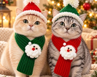May include: Two cats wearing festive crochet accessories. One cat wears a red hat with a white pom-pom and a green scarf with a Santa face. The other cat wears a green hat with a white pom-pom and a red scarf with a Santa face.