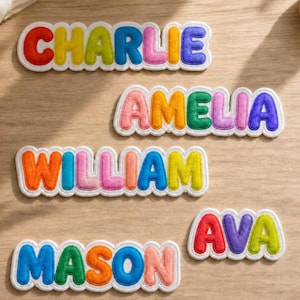 May include: Five embroidered name patches featuring the names CHARLIE, AMELIA, WILLIAM, MASON, and AVA. Each letter is rendered in a puffy, rounded font with a distinct color including red, orange, yellow, green, blue, purple, and pink, outlined in white.