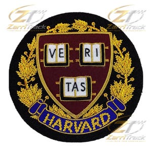 May include: A circular embroidered patch featuring a maroon shield with three white open books bearing the black text VERI TAS. The shield is surrounded by gold wheat stalks and a blue ribbon at the bottom with the gold embroidered text HARVARD.