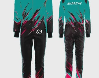 May include: A teal and black racing suit featuring a dynamic abstract pattern in pink and black. The front displays the number 03 in white, while the back features the name ANDREWS in white lettering. The suit has a full-length front zip.