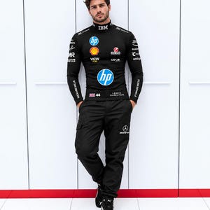 May include: A black long-sleeve mock neck shirt featuring various sponsor logos including HP, Shell, and IBM, paired with black cargo pants that have a Mercedes logo on the left leg and black athletic sneakers with white soles and laces.