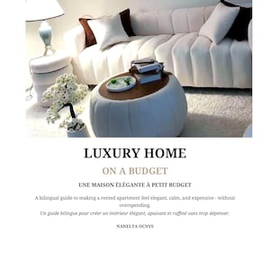 May include: A book cover titled LUXURY HOME ON A BUDGET, UNE MAISON &Eacute;L&Eacute;GANTE &Agrave; PETIT BUDGET by Nanelta Ocnys. The cover features a photograph of a white channel-tufted sofa, a round white ottoman, a table lamp, and a small potted white floral plant.