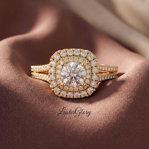 May include: A gold ring featuring a large round center stone surrounded by a double halo of smaller round stones. The band splits into two rows, each encrusted with small round stones. The text LusterGlory is printed below the ring.