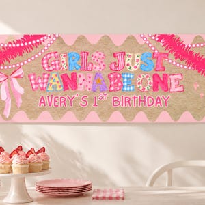 Pode incluir: Uma faixa retangular com centro castanho claro e bordas recortadas em rosa, apresentando o texto GIRLS JUST WANNA BE ONE e AVERY'S 1ST BIRTHDAY em letras coloridas e estampadas, decorada com laços cor-de-rosa e guirlandas de contas.