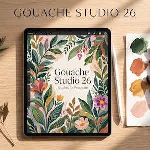 May include: A tablet displaying a digital illustration of colourful botanical leaves and flowers with the text Gouache Studio 26 Brushes for Procreate. A white stylus rests beside the tablet on a wooden surface with paint swatches.