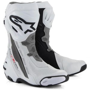 May include: A pair of white, black, and grey motorcycle boots featuring the Alpinestars logo and the text Supertech on the side. The boots have a perforated white leather toe and side panel, a black heel, and a white protective shin guard.