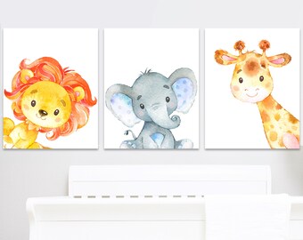 May include: Three watercolor animal prints featuring a lion, elephant, and giraffe. Each print has a white background and features a cartoon animal with a whimsical style.