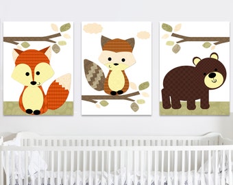 May include: Three nursery art prints featuring a brown bear, a fox with a brown and white tail, and a fox with an orange and white tail. The prints are on a white background with brown branches and green leaves.