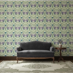 May include: A dark gray upholstered sofa with curved back and wooden legs, positioned against a wall covered in light green wallpaper featuring a repeating pattern of purple flowers and dark green stems, with a small round wooden side table nearby.