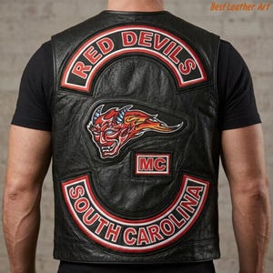 May include: A black leather vest featuring a large back patch with the text RED DEVILS in red and white, a central graphic of a red devil head with flames, a small MC patch, and a bottom patch reading SOUTH CAROLINA in red and white lettering.