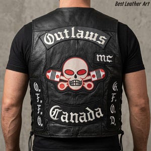 May include: A black leather waistcoat featuring embroidered patches on the back. The top patch reads Outlaws, the centre patch displays a skull with crossed pistons, and the bottom patch reads Canada. Side panels include the letters O.F.F.O and G.F.O.D.