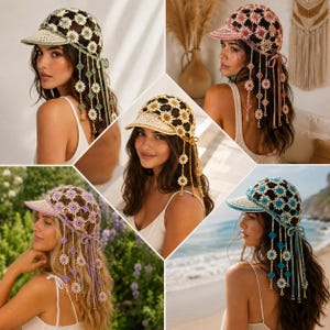 May include: A collection of five crochet baseball caps featuring a floral motif pattern. Each cap has a stiff brim and dangling crochet flower and diamond-shaped accents hanging from the sides. The caps are shown in green, pink, yellow, purple, and blue.