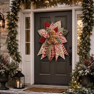 May include: A decorative fabric wreath featuring a central gingerbread person figure surrounded by layered, star-shaped petals in red, green, and white patterns, including plaid, stripes, and candy cane motifs, mounted on a dark grey front door.