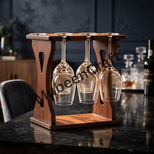 May include: A dark brown wooden wine glass rack with a rectangular base and two vertical supports featuring cutout shapes. The rack holds three clear glass wine glasses hanging upside down by their stems, arranged in a single row across the top.