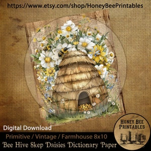 May include: A digital printable featuring a beehive skep surrounded by white daisies and yellow wildflowers. The beehive is made of straw and has a small opening at the bottom. The background is a vintage dictionary page. The text "Honey Bee Printables" is in the lower right corner of the image.
