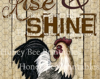 May include: A rooster with black, white, and gray feathers stands on a wooden background with a chicken wire pattern. The text "Rise & Shine" is written in brown letters above the rooster.