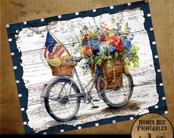 May include: A vintage-style bicycle with a basket filled with red, white, and blue flowers. An American flag is attached to the handlebars. The bicycle is on a white wooden background with a blue border.