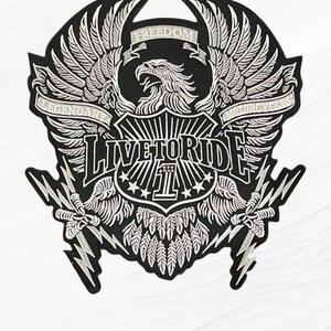 May include: A black and white embroidered patch featuring a central eagle with spread wings, a shield with the number 1, and lightning bolts. The text reads FREEDOM, LEGENDARY, MOTORCYCLES, and LIVE TO RIDE in bold, stylized lettering.