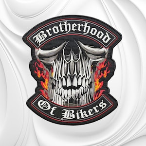 May include: An embroidered patch featuring a central white and gray skull graphic surrounded by orange and red flames. The text Brotherhood is arched at the top and Of Bikers is arched at the bottom in a white gothic font on black.
