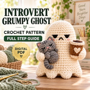 May include: A crochet pattern digital PDF titled INTROVERT GRUMPY GHOST. The image features a cream-colored crocheted ghost holding a small gray tabby cat and a brown coffee cup with a white heart. Text includes CROCHET PATTERN and FULL STEP GUIDE.