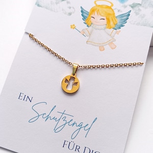 May include: A gold necklace with a small angel pendant. The pendant is a cutout of an angel with wings. The necklace is on a white card with the text "EIN Schutzengel F&Uuml;R DICH".