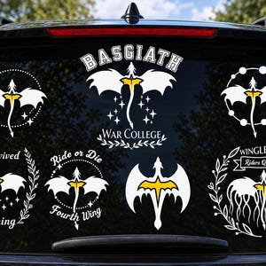 May include: A collection of white and yellow dragon-themed vinyl decals applied to a car window. Designs include Basgiath War College, I Survived Threshing, Ride or Die Fourth Wing, and Wingleader Riders Quadrant with various dragon silhouettes.