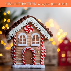 May include: A crochet gingerbread house pattern PDF titled CROCHET PATTERN in English. The house features a brown roof with white fringe, two windows, a central door with a red and white candy cane trim, and a red and white peppermint candy accent.